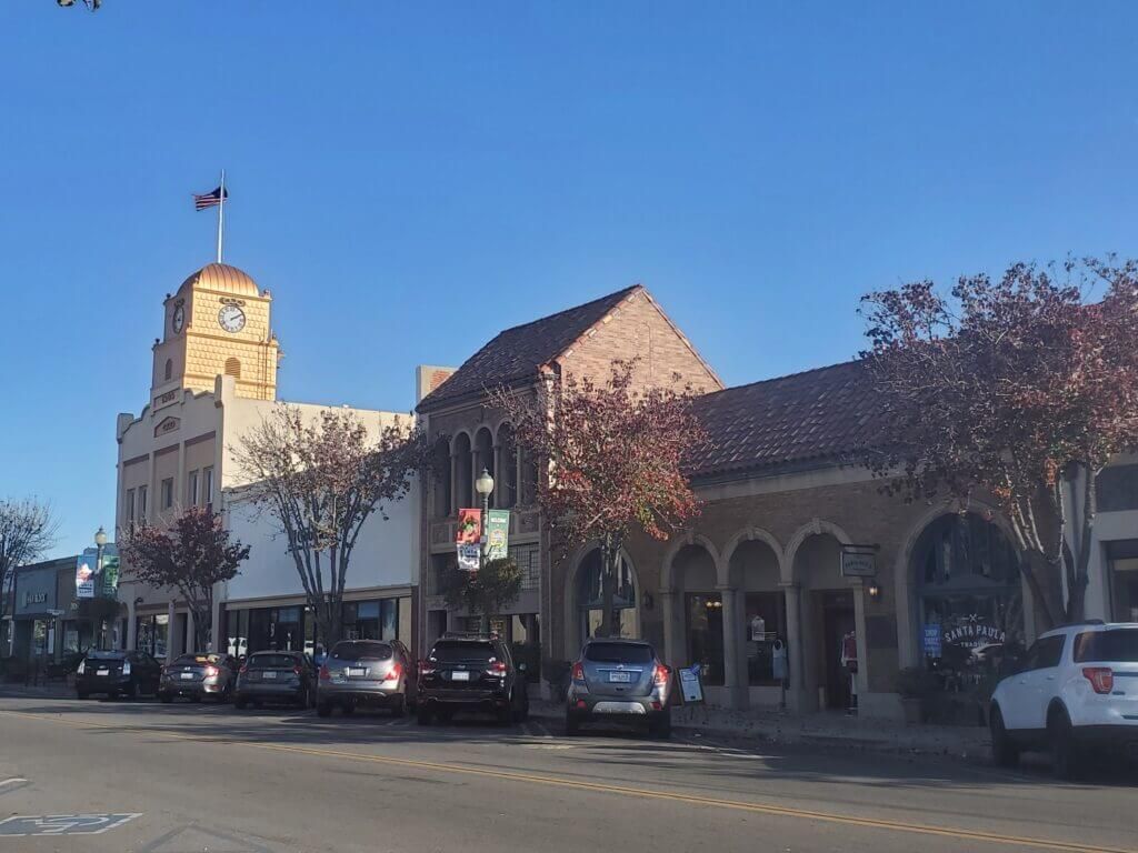 The historic downtown has beautiful buildings with arches, murals and the old clock tower shines in the sunlight.